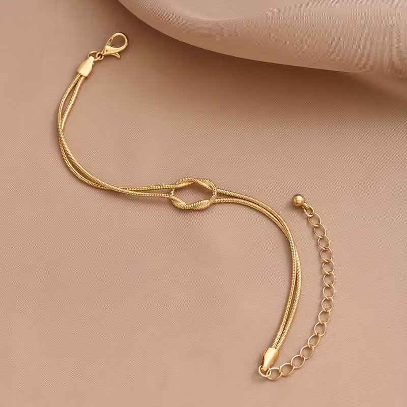 Zlatý náramek s mašlí